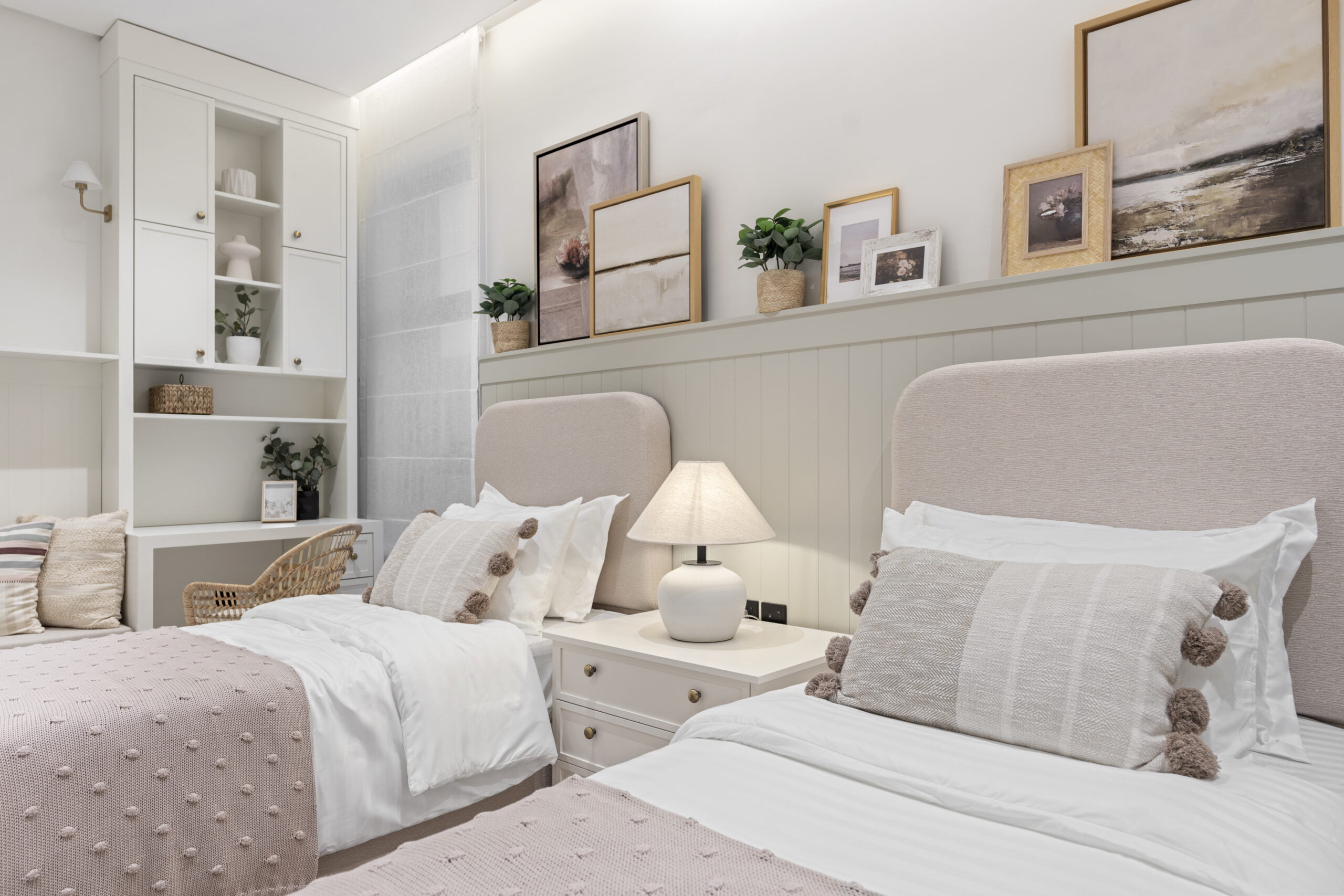 close up bedroom image with paintings on the wall