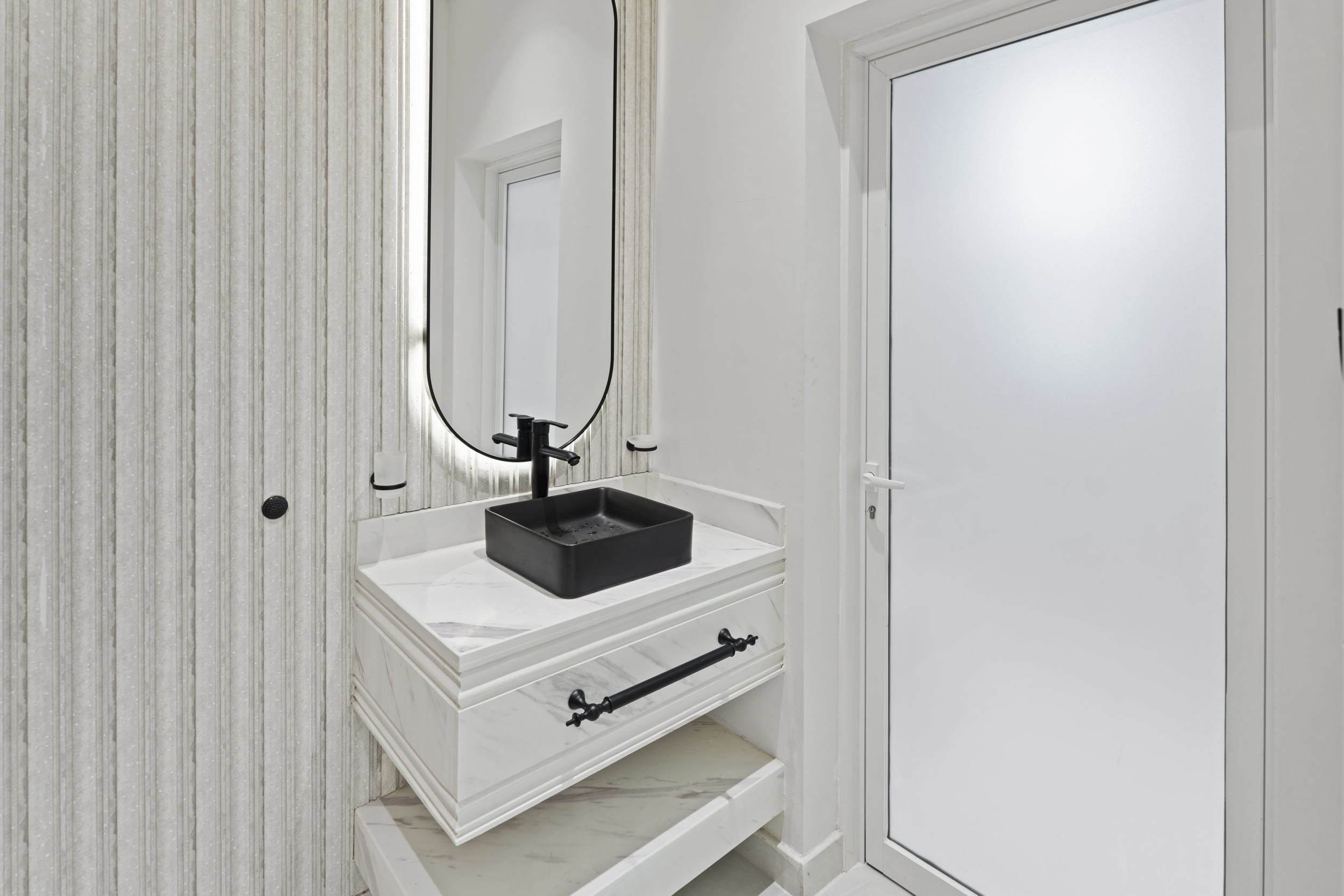 white bathroom with black sink