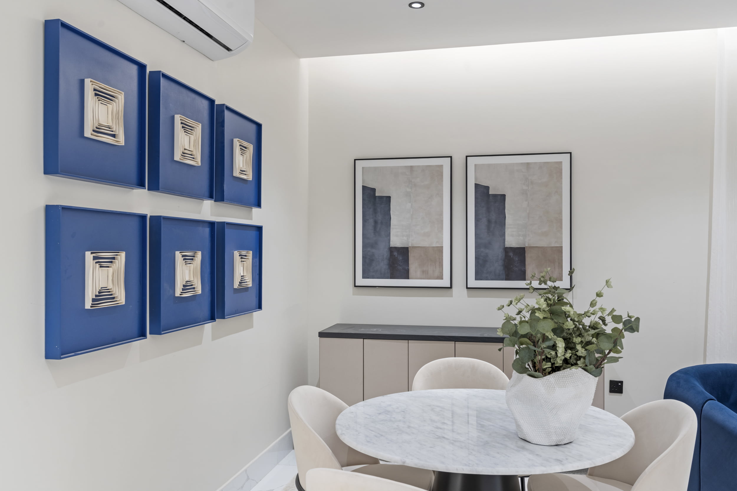 food table with paintings on the wall blue hint and decorative
