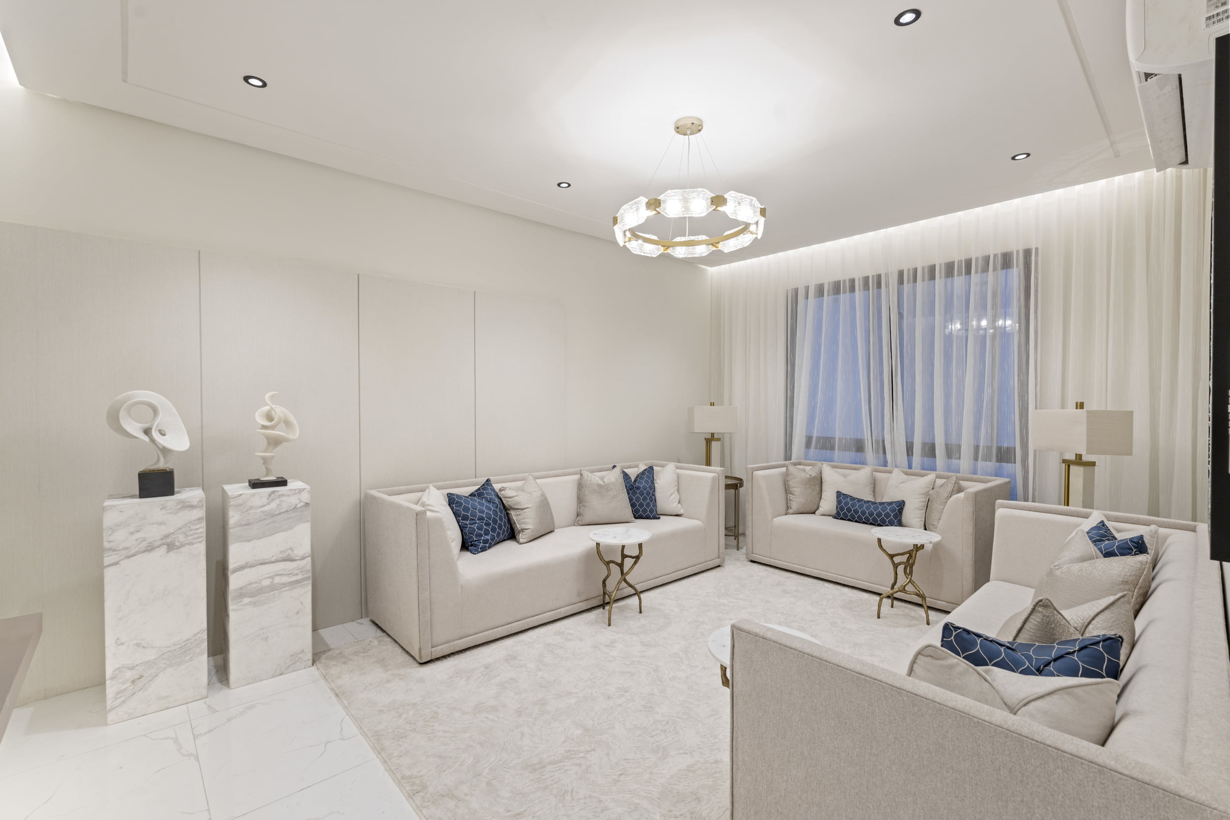 spacious living room with large sofa and blue pillows