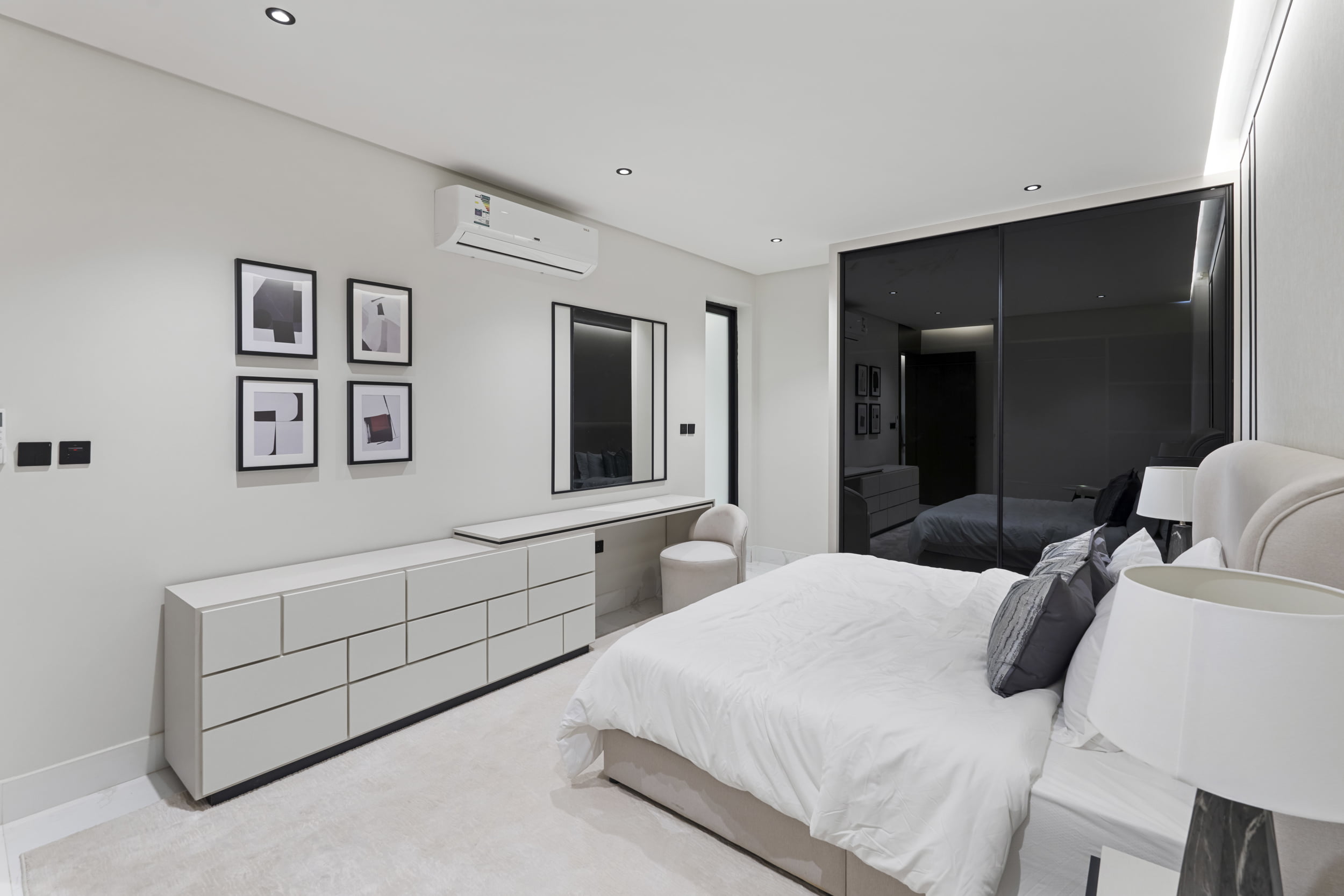 white master bedroom with black large cabinet